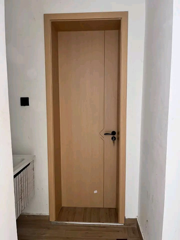 Natural oak flush door installed in a finished interior