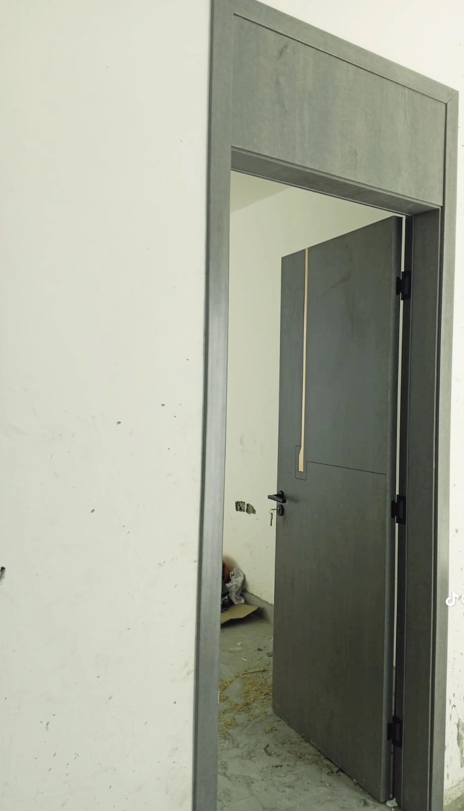 Dark graphite grey flush door installed with matching grey frame